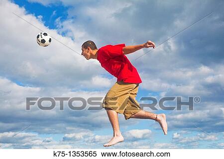 Hitting soccer ball high in the sky View Large Photo Image Stock Photography - Hitting soccer ball high in the sky. Fotosearch