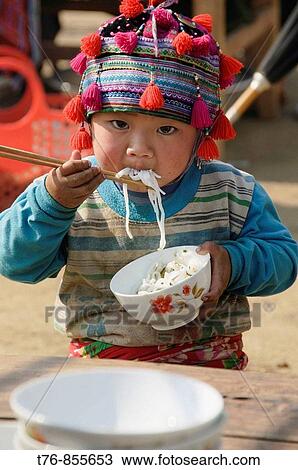 Hmong boy stuffing his face with noodles at market in Tam Duong near Sapa Vietnam View Large Photo Image Stock Image - Hmong boy stuffing his face with noodles at market in Tam Duong near Sapa Vietnam. Fotosearch