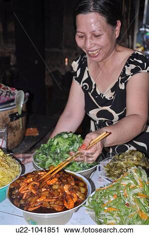 Hoi An (Vietnam): food seller at the market View Large Photo Image Stock Image - Hoi An (Vietnam): food seller at the market. Fotosearch
