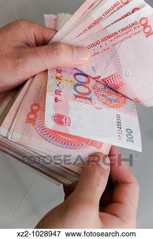 Holding a lot of money View Large Photo Image Stock Photo - Holding a lot of money. Fotosearch