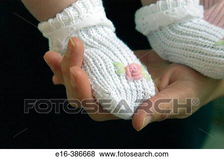 Stock Photo - holding baby feet. Fotosearch