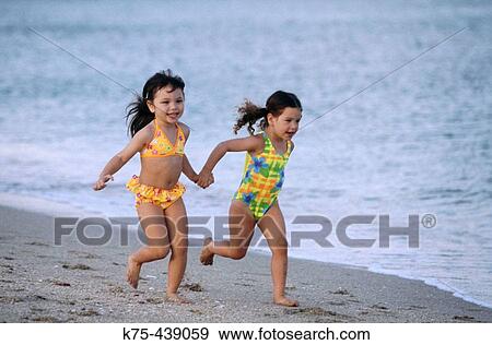 holding hands and running down the beach View Large Photo Image Stock Photo - holding hands and running down the beach. Fotosearch