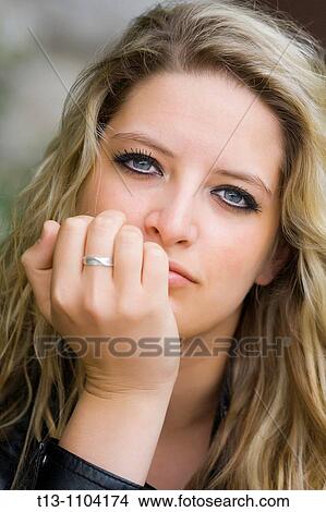 Picture - Holding her chin. Fotosearch