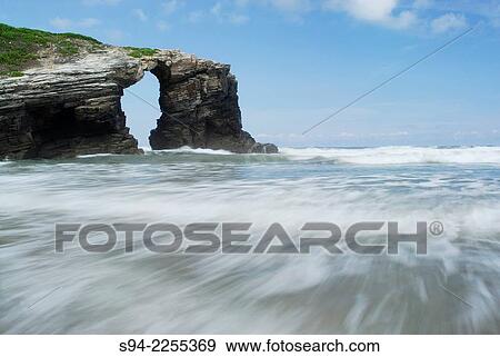Hole rock in a beach called Praia das Catedrais in the north coast of Spain, Lugo, Spain. View Large Photo Image Stock Photo - Hole rock in a beach called Praia das Catedrais in the north coast of Spain, Lugo, Spain.. Fotosearch