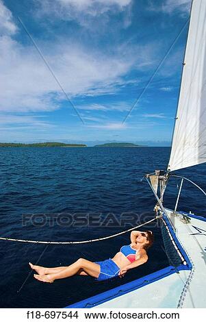 Holiday maker relaxing on sailing charter vessel, Vava? u, Kingdom of Tonga, South Pacific. View Large Photo Image Picture - Holiday maker relaxing on sailing charter vessel, Vava? u, Kingdom of Tonga, South Pacific.. Fotosearch