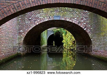 Holland, Limburg region, Den Bosch, round by boat on the Binnendieze channel, in the Den Bosch cellars View Large Photo Image Stock Image - Holland, Limburg region, Den Bosch, round by boat on the Binnendieze channel, in the Den Bosch cellars. Fotosearch