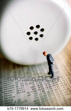 hombre de negocios de pi? sobre papeles de nmeros y con un auricular de tel? fono, businessman standing on papers with numbers and a telephone, View Large Photo Image Picture - hombre de negocios de pi? sobre papeles de nmeros y con un auricular de tel? fono, businessman standing on papers with numbers and a telephone,. Fotosearch