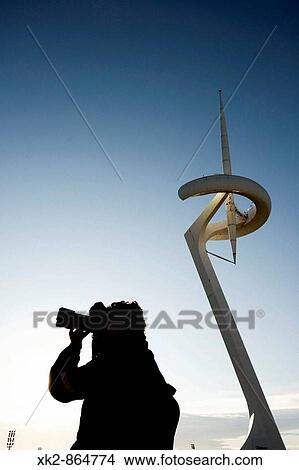 Hombre fotografiando en torre de telecomunicaciones telef? nica de Montjuic, Barcelona View Large Photo Image Picture - Hombre fotografiando en torre de telecomunicaciones telef? nica de Montjuic, Barcelona. Fotosearch