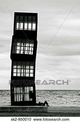 Hombre tumbado en la Escultura de Rebecca Horn en la playa de la Barceloneta, Barcelona View Large Photo Image Stock Image - Hombre tumbado en la Escultura de Rebecca Horn en la playa de la Barceloneta, Barcelona. Fotosearch