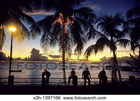 hommes assis au bord de l? ocean au crepuscule Ile de la Martinique Departement et Region d? Outremer francais Archipel des Antilles Caraibes View Large Photo Image Stock Photograph - hommes assis au bord de l? ocean au crepuscule Ile de la Martinique Departement et Region d? Outremer francais Archipel des Antilles Caraibes. Fotosearch