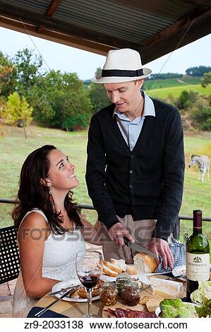 Honeymooning couple in late twenties eating picnic lunch with zebras in background, in the Winelands, Western Cape, Stellenbosch, South Africa. View Large Photo Image Stock Photo - Honeymooning couple in late twenties eating picnic lunch with zebras in background, in the Winelands, Western Cape, Stellenbosch, South Africa.. Fotosearch