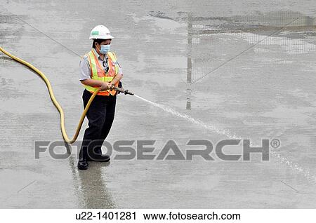 Hong Kong: a man at work watering the pavement by the construction of the new pier on Victoria Harbour, in Central View Large Photo Image Stock Image - Hong Kong: a man at work watering the pavement by the construction of the new pier on Victoria Harbour, in Central. Fotosearch