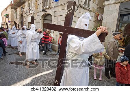 Stock Image - Hooded men in procession on Good Friday, Troia, Apulia, Italy. Fotosearch