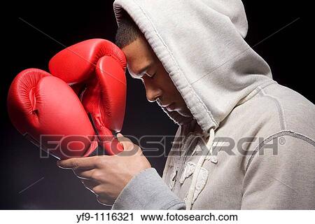 Stock Image - Hooded young man boxer.. Fotosearch