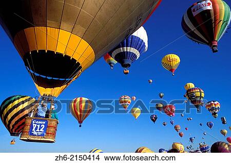 Hot air balloons rising in dawn light at the International Balloon Fiesta, Albuquerque, New Mexico USA. View Large Photo Image Picture - Hot air balloons rising in dawn light at the International Balloon Fiesta, Albuquerque, New Mexico USA.. Fotosearch