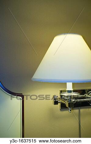 Hotel room lamp shade next to bed View Large Photo Image Stock Photography - Hotel room lamp shade next to bed. Fotosearch