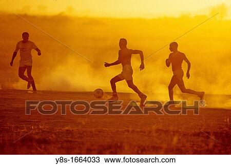Stock Image - Hotel Staff Members playing Soccer at Amboseli National Park. Fotosearch