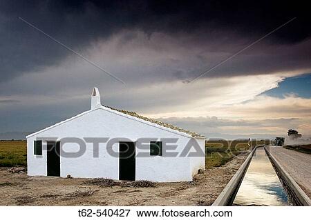 House. Rice field, Ebro River delta. Tarragona province, Catalonia, Spain View Large Photo Image Stock Photo - House. Rice field, Ebro River delta. Tarragona province, Catalonia, Spain. Fotosearch