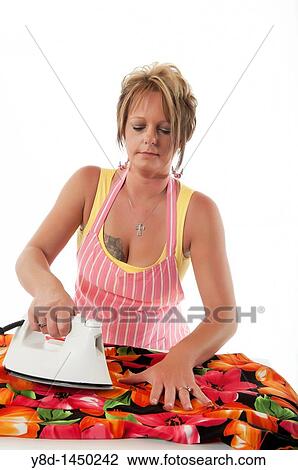Stock Image - Housewife ironing laundry. Fotosearch