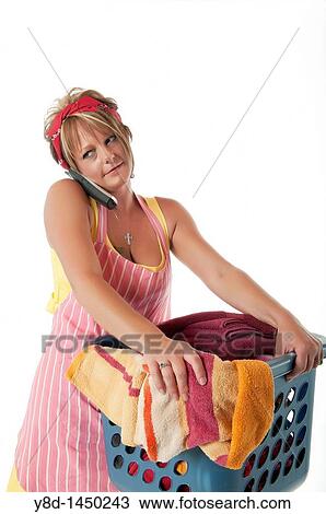 Stock Image - Housewife with laundry basket and phone. Fotosearch
