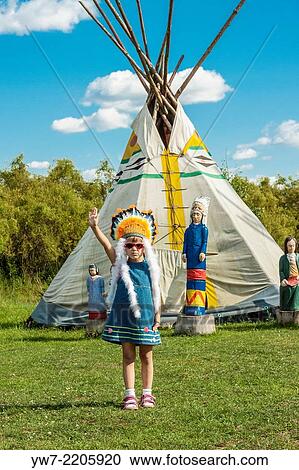 Stock Image - Howgh! Girl wearing war bonnet in Western City - Kraina Westernu - in Sarnowa Gora, Poland.. Fotosearch