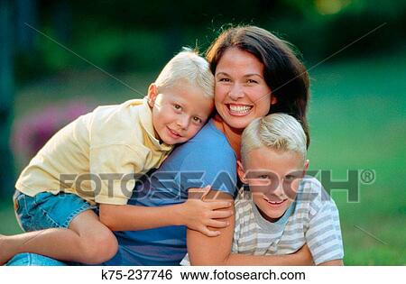 Stock Photograph - Hugs for mom and her sons. Fotosearch