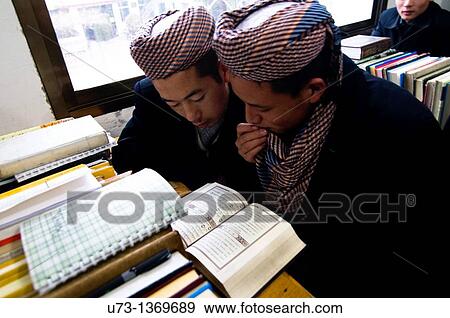 Stock Photo - Hui Muslim boys studying the Qur? an in a Medressa in Gansu province. Fotosearch