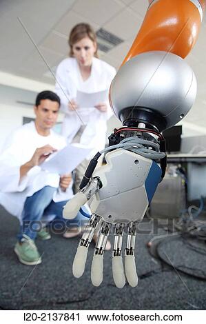 Stock Image - Humanoid robot for automotive assembly tasks in collaboration with people and and LWR robot, using haptic teleoperation with force feedback.. Fotosearch