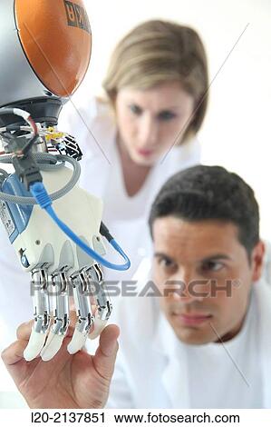 Stock Image - Humanoid robot for automotive assembly tasks in collaboration with people and and LWR robot, using haptic teleoperation with force feedback.. Fotosearch