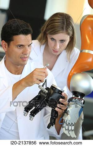 Stock Photograph - Humanoid robot for automotive assembly tasks in collaboration with people and and LWR robot, using haptic teleoperation with force feedback.. Fotosearch