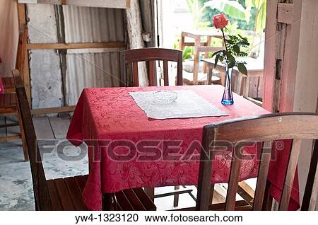 Stock Image - Humble French style cafe with a rose on a table, Luang Prabang, Laos. Fotosearch