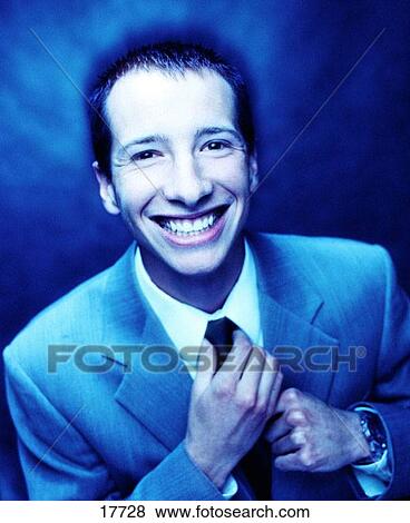 humorous young male adult straighting neck tie View Large Photo Image Stock Photo - humorous young male adult straighting neck tie. Fotosearch