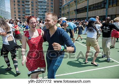Stock Image - Hundreds of Lindy Hop enthusiasts converge on Harlem in New York to celebrate World Lindy Hop Day and the centennial birthday of the late Frankie Manning with a dance party and a parade.. Fotosearch