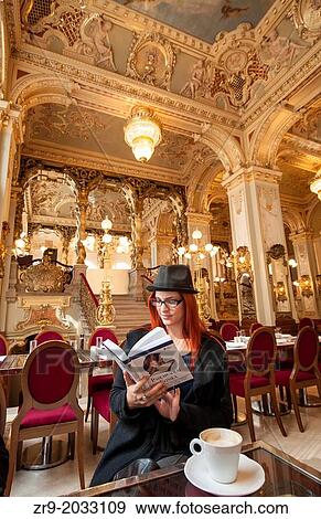 Hungarian red-haired woman reading a book in New York Cafe, an opulent 19th century coffee house once frequented by writers in Budapest, Hungary. View Large Photo Image Stock Photo - Hungarian red-haired woman reading a book in New York Cafe, an opulent 19th century coffee house once frequented by writers in Budapest, Hungary.. Fotosearch