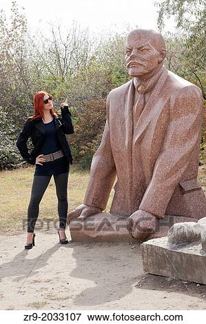 Hungarian woman pointing finger at statue of Lenin while visiting Memento Statue Park in Budapest, Hungary. View Large Photo Image Stock Photo - Hungarian woman pointing finger at statue of Lenin while visiting Memento Statue Park in Budapest, Hungary.. Fotosearch
