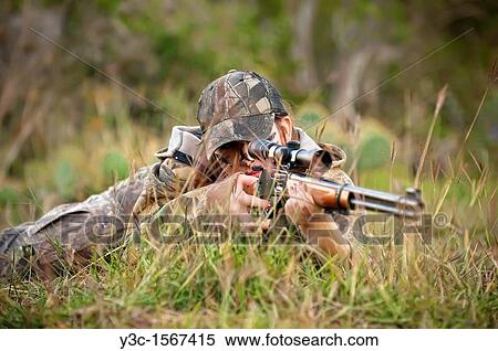 Hunting Season - female hunter lying on the ground ready to shoot rifle View Large Photo Image Stock Photography - Hunting Season - female hunter lying on the ground ready to shoot rifle. Fotosearch