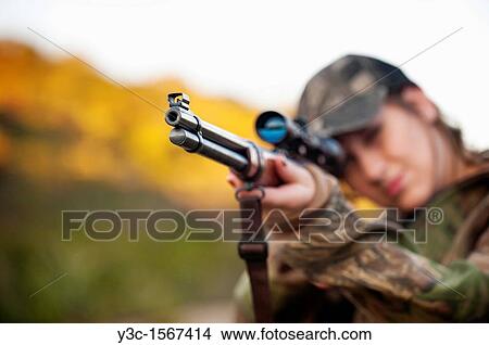 Hunting Season - Female hunter shooting firearm gun View Large Photo Image Picture - Hunting Season - Female hunter shooting firearm gun. Fotosearch