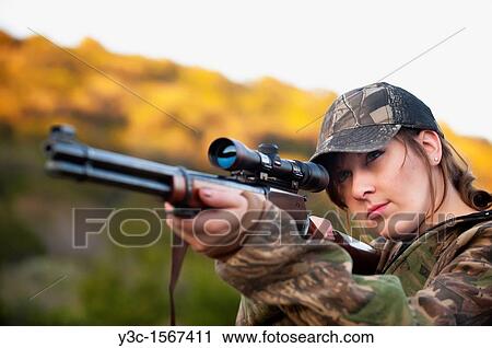 Hunting woman firing rifle gun View Large Photo Image Stock Image - Hunting woman firing rifle gun. Fotosearch