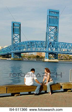Stock Photograph - Husband and wife couple relax by the Bridges in the city of Jacksonville, Florida. USA.. Fotosearch