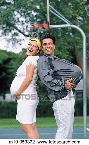 Husband imitating pregnant wife View Large Photo Image Stock Image - Husband imitating pregnant wife. Fotosearch