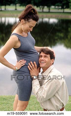 husband listening to pregnant wife's belly View Large Photo Image Stock Image - husband listening to pregnant wife's belly. Fotosearch