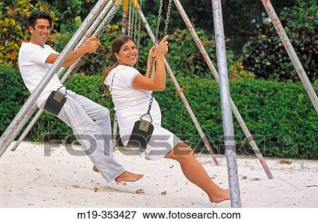 husband with his pregnant wife on a swing View Large Photo Image Stock Photo - husband with his pregnant wife on a swing. Fotosearch