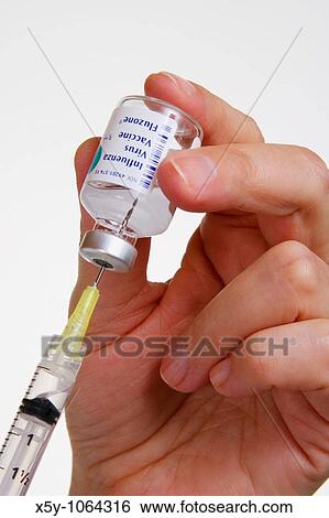 Hypodermic syringe being filled with vaccine View Large Photo Image Stock Photograph - Hypodermic syringe being filled with vaccine. Fotosearch