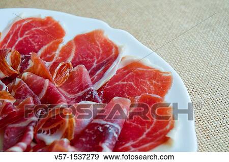 Stock Photo - Iberian Ham serving, close view. Spain.. Fotosearch
