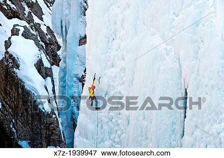 Stock Photo - Ice climbing a route called Hardline which is rated WI-5 at The Ouray Ice Park in the Uncompahgre River Gorge near the town of Ouray in southwestern Colorado.. Fotosearch