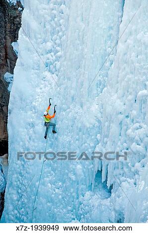 Stock Photo - Ice climbing a route called Hardline which is rated WI-5 at The Ouray Ice Park in the Uncompahgre River Gorge near the town of Ouray in southwestern Colorado.. Fotosearch