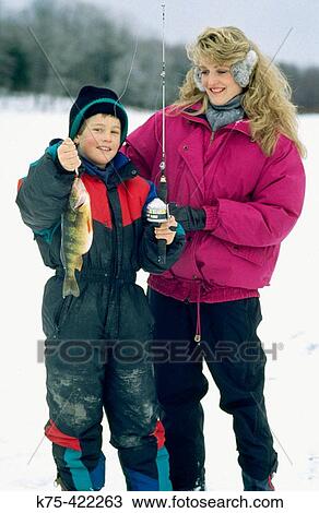 Stock Image - Ice fishing for yellow perch. Fotosearch