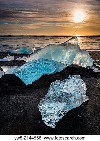 Ice on black sands. Ice formations come from the Jokulsarlon Glacial Lagoon, Breidamerkurjokull Glacier, Vatnajokull Ice Cap, Iceland. View Large Photo Image Stock Photograph - Ice on black sands. Ice formations come from the Jokulsarlon Glacial Lagoon, Breidamerkurjokull Glacier, Vatnajokull Ice Cap, Iceland.. Fotosearch