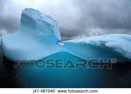 Iceberg and storm clouds. Gerlache Strait. Antarctic Peninsula. Antarctica. View Large Photo Image Stock Image - Iceberg and storm clouds. Gerlache Strait. Antarctic Peninsula. Antarctica.. Fotosearch