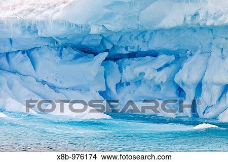 Iceberg detail in and around the Antarctic Peninsula during the summer months More icebergs are being created as global warming is causing the breakup of major ice shelves and glaciers View Large Photo Image Picture - Iceberg detail in and around the Antarctic Peninsula during the summer months More icebergs are being created as global warming is causing the breakup of major ice shelves and glaciers. Fotosearch